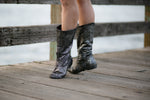 Aurora dance boots silver metallic pair folded up in action on wooden dock