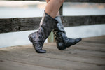 Aurora dance boots silver metallic pair folded up apple jacks wooden dock background