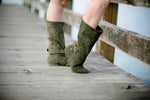 Aurora dance boots dark/olive green pair folded up on wooden dock background