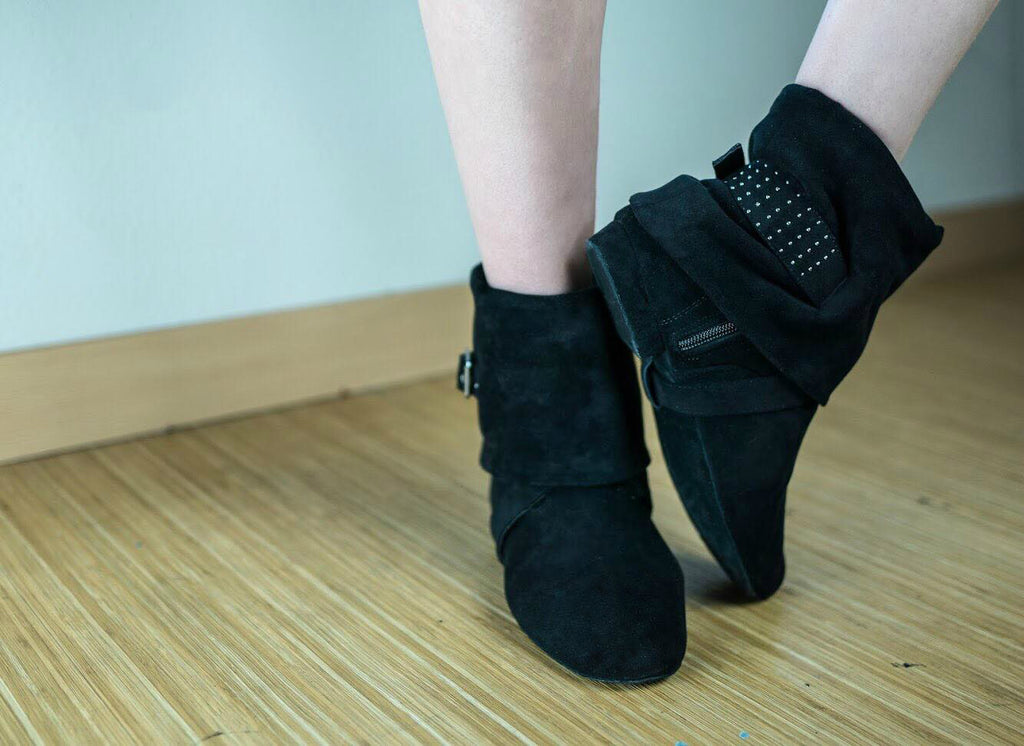Aurora dance boots black pair folded down on wood floor